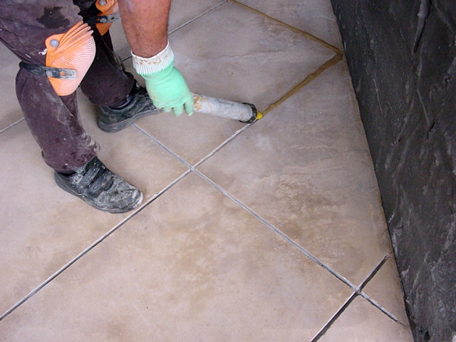 Grout being applied with a PFL grout gun.
